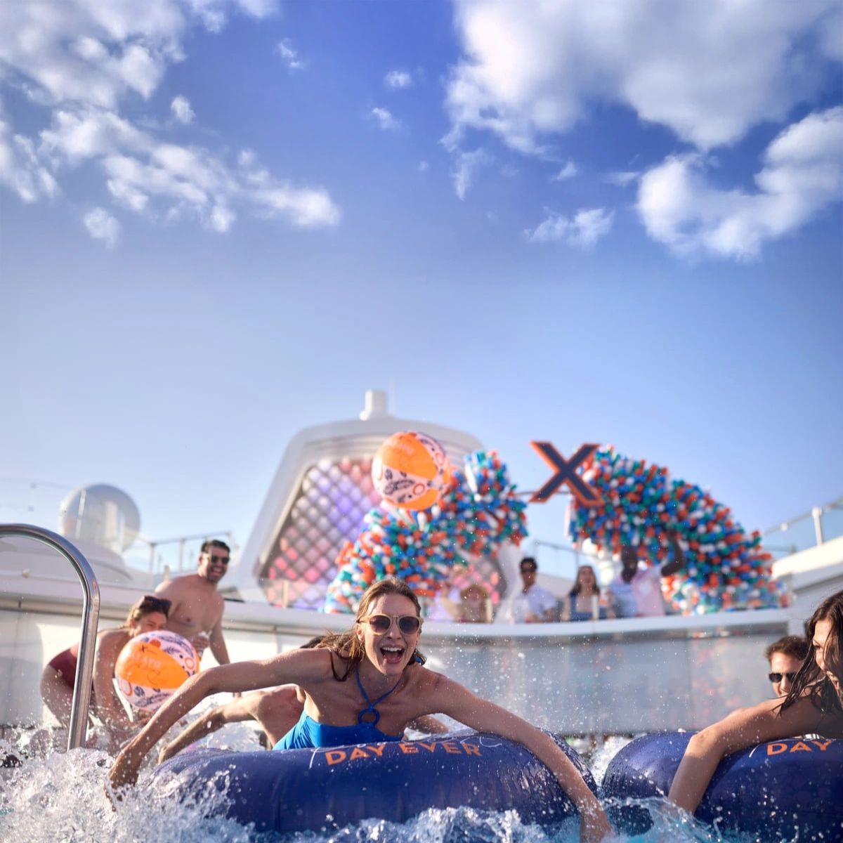 Travelers enjoying water slides aboard a Celebrity cruise ship
